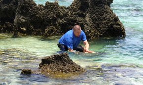 Adam McGeorge in the water at the reef in Nauru